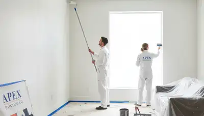Professional interior house painters working in Atlanta, GA living room with modern color finishes