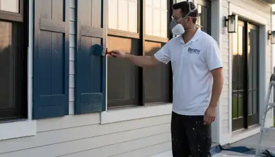 Professional painters refinishing home shutters with durable exterior paint in Atlanta, GA